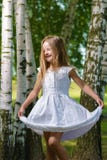 Happy child is dancing and playing in white dress stock photo Happy child is dancing and playing in white dress stock photo