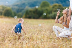 Happy child with family having a great time blowing bubbles stock photography Happy child with family having a great time blowing bubbles stock photography