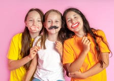 Happy Children Hold Fake Mustache And Lips On A Pink Background. Beauty Salon. Hair Design Salon. Salon Photobooth Stock Photography