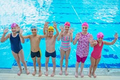 Happy children kids group at swimming pool class learning to swim royalty free stock images Happy children kids group at swimming pool class learning to swim royalty free stock images