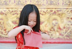 Happy Chinese New Year Festival. Smiling Little Asian Girl Holding Red Envelope Royalty Free Stock Photos Happy Chinese New Year Festival. Smiling Little Asian Girl Holding Red Envelope Royalty Free Stock Photos