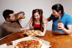 Happy company of youth eating a pizza Royalty Free Stock Photo Happy company of youth eating a pizza Royalty Free Stock Photo