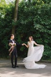 Happy Couple of Bride and groom walking in a park . Happy newlyweds at wedding in nature green forest. photo portrait royalty free stock photography Happy Couple of Bride and groom walking in a park . Happy newlyweds at wedding in nature green forest. photo portrait royalty free stock photography