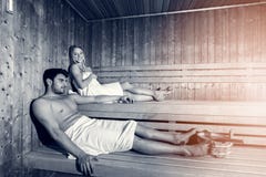 Happy couple enjoying the sauna together at the spa stock photos Happy couple enjoying the sauna together at the spa stock photos