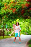 Happy couple having fun in blooming park Royalty Free Stock Photos Happy couple having fun in blooming park Royalty Free Stock Photos