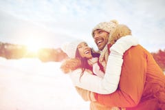 Happy couple hugging outdoors in winter