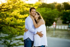 Happy couple in love together in park landscape on sunset with woman pregnant belly and man stock photography Happy couple in love together in park landscape on sunset with woman pregnant belly and man stock photography