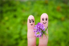 Happy couple. Man is giving flowers to a woman Royalty Free Stock Photos Happy couple. Man is giving flowers to a woman Royalty Free Stock Photos