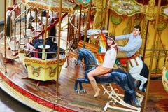 Happy couple on the merry-go-round in Paris Royalty Free Stock Photos Happy couple on the merry-go-round in Paris Royalty Free Stock Photos