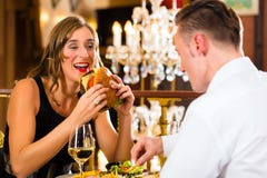 https://thumbs.dreamstime.com/t/happy-couple-restaurant-eat-fast-food-men-women-fine-dining-burger-fries-large-chandelier-background-35911291.jpg