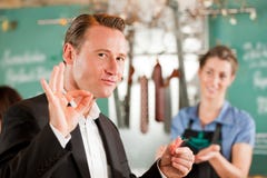 Happy Customer At Butcher Shop royalty free stock image Happy Customer At Butcher Shop royalty free stock image