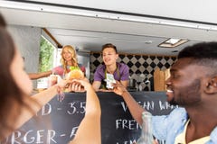 Happy customers buying burger at food truck Royalty Free Stock Images Happy customers buying burger at food truck Royalty Free Stock Images