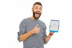 Happy delighted man enjoying using a search website stock image Happy delighted man enjoying using a search website stock image