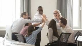 Happy diverse employees business team engaged in teambuilding giving high-five