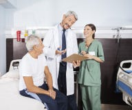 Happy Doctor Explaining Report To Senior Patient In Rehab Center stock images Happy Doctor Explaining Report To Senior Patient In Rehab Center stock images