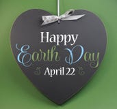Happy Earth Day April 22, message sign greeting on a heart shaped blackboard Royalty Free Stock Photos Happy Earth Day April 22, message sign greeting on a heart shaped blackboard Royalty Free Stock Photos