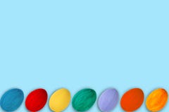 Happy Easter card. Colorful shiny easter eggs on blue background. Copy space for text. royalty free stock image Happy Easter card. Colorful shiny easter eggs on blue background. Copy space for text. royalty free stock image