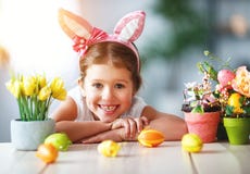 Happy easter! funny child girl with rabbit ears and . eggs stock photo Happy easter! funny child girl with rabbit ears and . eggs stock photo