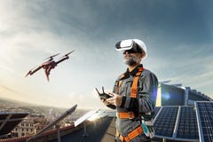 Happy engineer using drone and vr helmet for cheking solar station. in roof