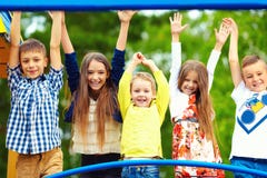 Happy excited kids having fun together on playground stock photo Happy excited kids having fun together on playground stock photo