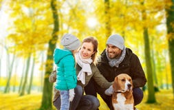 Happy family with beagle dog in autumn park stock photography Happy family with beagle dog in autumn park stock photography