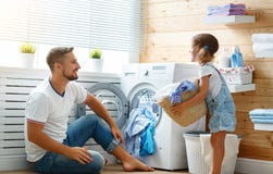 Happy family father and child in laundry stock photo Happy family father and child in laundry stock photo