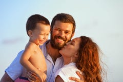 Happy family - father, mother, baby on sunset beach stock images Happy family - father, mother, baby on sunset beach stock images