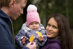 Happy family: Father, Mother and child - in autumn park: dad, mammy baby posing outdoor, girl holding in the hands of stock photos Happy family: Father, Mother and child - in autumn park: dad, mammy baby posing outdoor, girl holding in the hands of stock photos