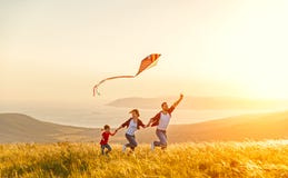 Happy family father of mother and child daughter launch a kite o Stock Images Happy family father of mother and child daughter launch a kite o Stock Images