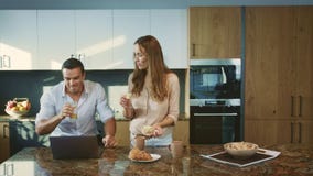 Happy family having breakfast at kitchen. Smiling couple talking at home. stock footage Happy family having breakfast at kitchen. Smiling couple talking at home. stock footage