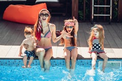 Happy family having fun time at the pool side stock photo Happy family having fun time at the pool side stock photo