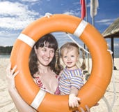 Happy family with life buoy. stock photo Happy family with life buoy. stock photo
