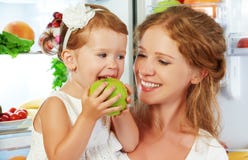 happy family mother and child with healthy food fruits and vegetables