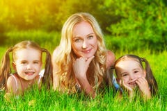 happy family mother and children twin sisters on meadow in summer on grass stock image happy family mother and children twin sisters on meadow in summer on grass stock image