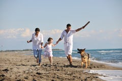 Happy family playing with dog on beach Royalty Free Stock Photo Happy family playing with dog on beach Royalty Free Stock Photo