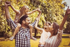 Happy family playing in the meadow together and enjoying in sum stock photo Happy family playing in the meadow together and enjoying in sum stock photo