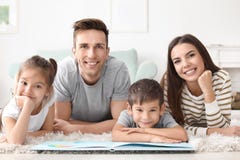 Happy family reading book stock image Happy family reading book stock image