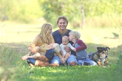 Happy Family Relaxing Outside with Dog stock images Happy Family Relaxing Outside with Dog stock images