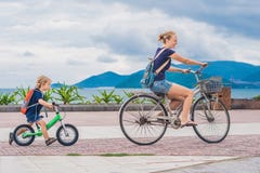 Happy family is riding bikes outdoors and smiling. Mom on a bike royalty free stock photos Happy family is riding bikes outdoors and smiling. Mom on a bike royalty free stock photos