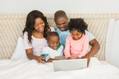 Happy family shopping online with laptop Stock Image Happy family shopping online with laptop Stock Image
