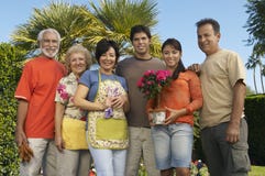 Happy Family Standing Together In Garden Stock Photo Happy Family Standing Together In Garden Stock Photo