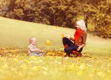 Happy family at sunny autumn day, mother playing with her child stock images Happy family at sunny autumn day, mother playing with her child stock images