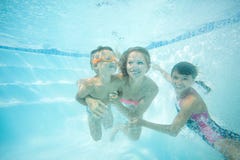 Happy family swimming underwater. Mother, son and daughter having having fun in pool. Stock Image Happy family swimming underwater. Mother, son and daughter having having fun in pool. Stock Image