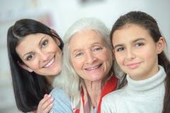 Happy family three generations smiling and looking at camera Royalty Free Stock Photo Happy family three generations smiling and looking at camera Royalty Free Stock Photo