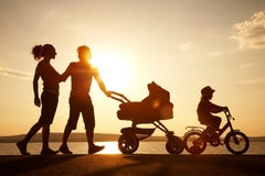 Happy family walking on sunset stock photo Happy family walking on sunset stock photo