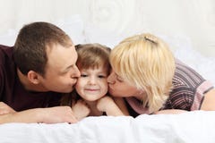 Happy Father And Mother Lie On Bed And Kiss Little Stock Image Happy Father And Mother Lie On Bed And Kiss Little Stock Image