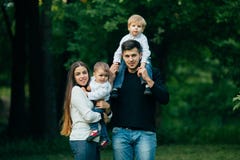 Happy father, mother and two sons spending time in park. royalty free stock photo Happy father, mother and two sons spending time in park. royalty free stock photo