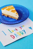 Happy Father`s day, International Men`s day or Birthday card. Colored greeting card made by children and piece of cake on blue p