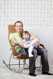 Happy Father Sits With Little Daughter In Rocking Chair Stock Photo Happy Father Sits With Little Daughter In Rocking Chair Stock Photo