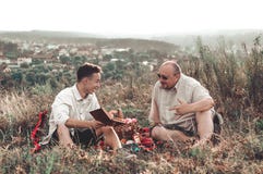 Happy father and son having a rest on nature on a summer day royalty free stock photo Happy father and son having a rest on nature on a summer day royalty free stock photo
